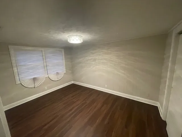 a view of a room with wooden floor and exposed radiator