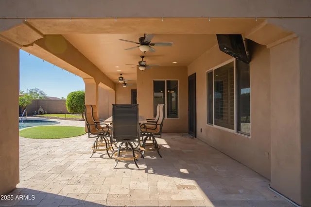 a view of a patio with a table and chairs
