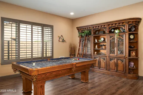 a room with furniture pool table and windows