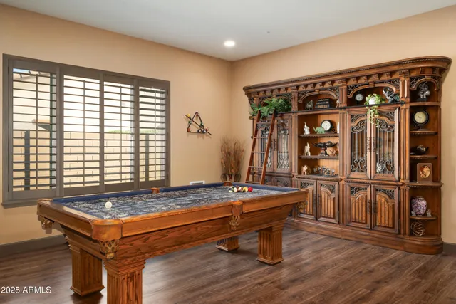 a room with furniture pool table and windows