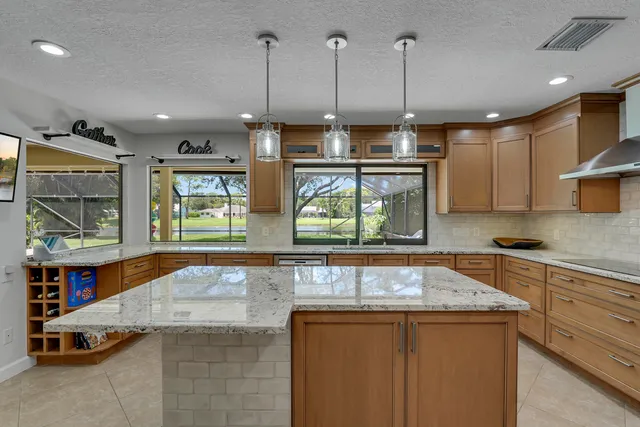 a kitchen with stainless steel appliances granite countertop a refrigerator and a sink