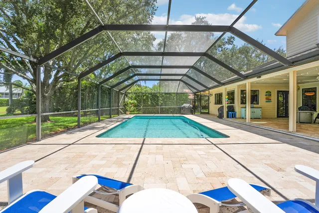a view of a patio with table and chairs with wooden floor and fence