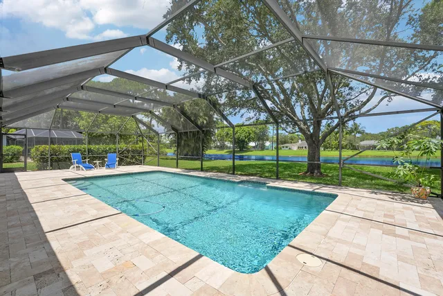 a view of a patio with a table chairs and a backyard