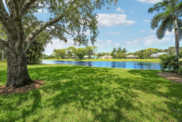 a view of a house with a yard and lake view