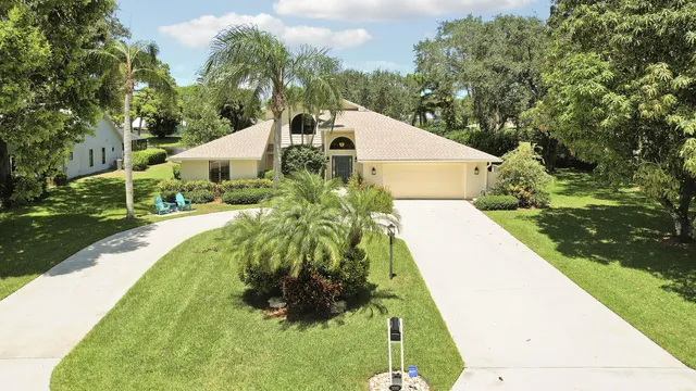 a front view of house with yard and green space