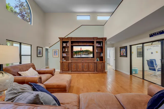 a view of a livingroom with wooden floor and furniture