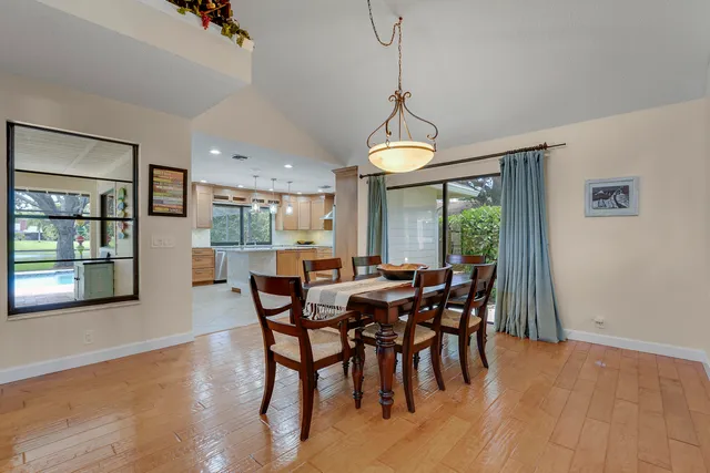 a large kitchen with stainless steel appliances granite countertop a stove and a sink