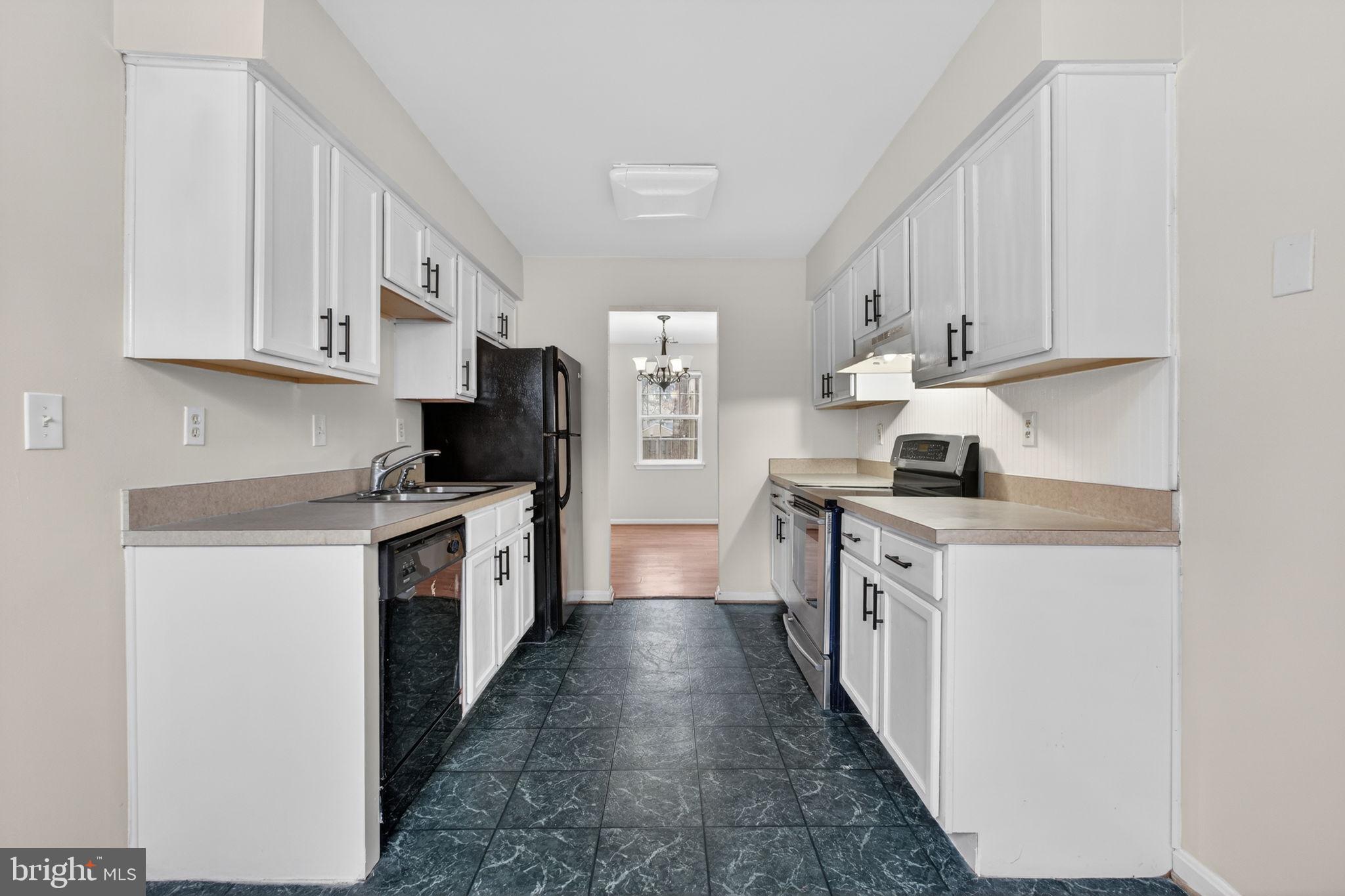 3362 Ryon Court Waldorf, MD 20601 - Photo 18 of 42 a kitchen with granite countertop a sink a stove top oven and white cabinets