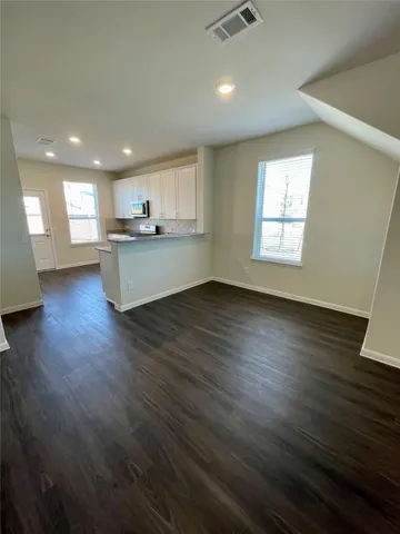 an open kitchen with sink and cabinets