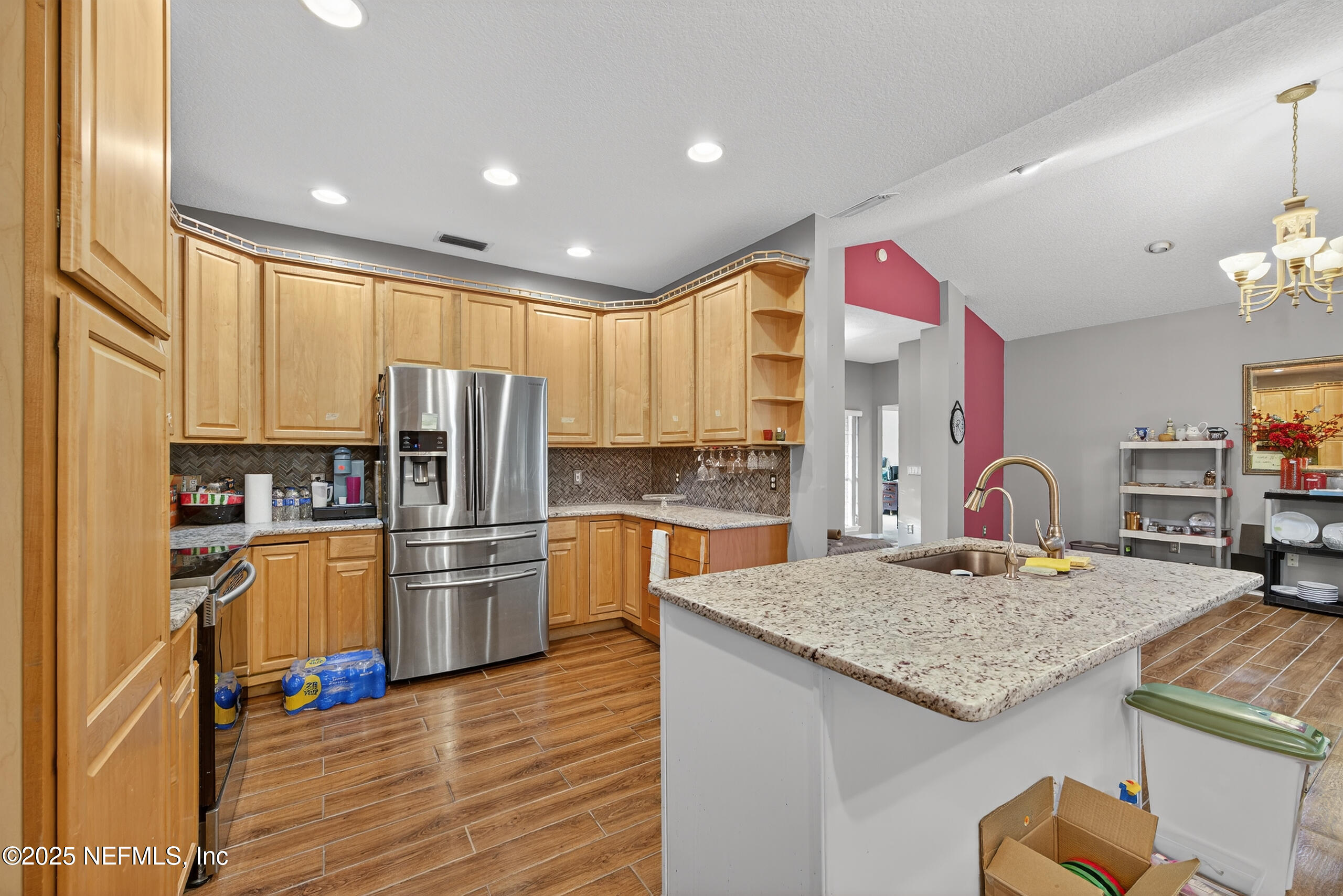 11319 Simmons Road Jacksonville, FL 32218 - Photo 11 of 32 a kitchen with refrigerator cabinets and wooden floor
