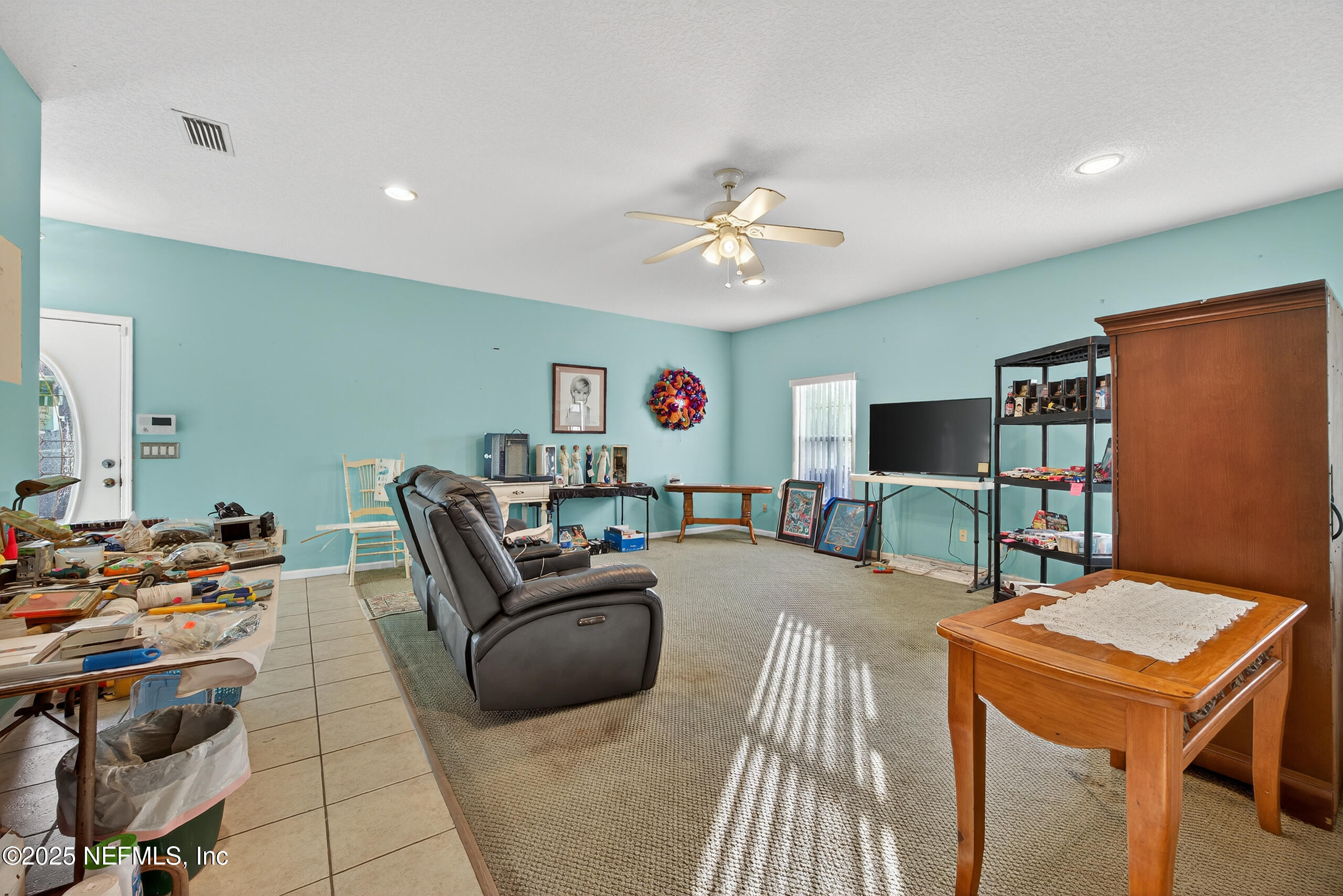 11319 Simmons Road Jacksonville, FL 32218 - Photo 13 of 32 a living room with furniture and a flat screen tv
