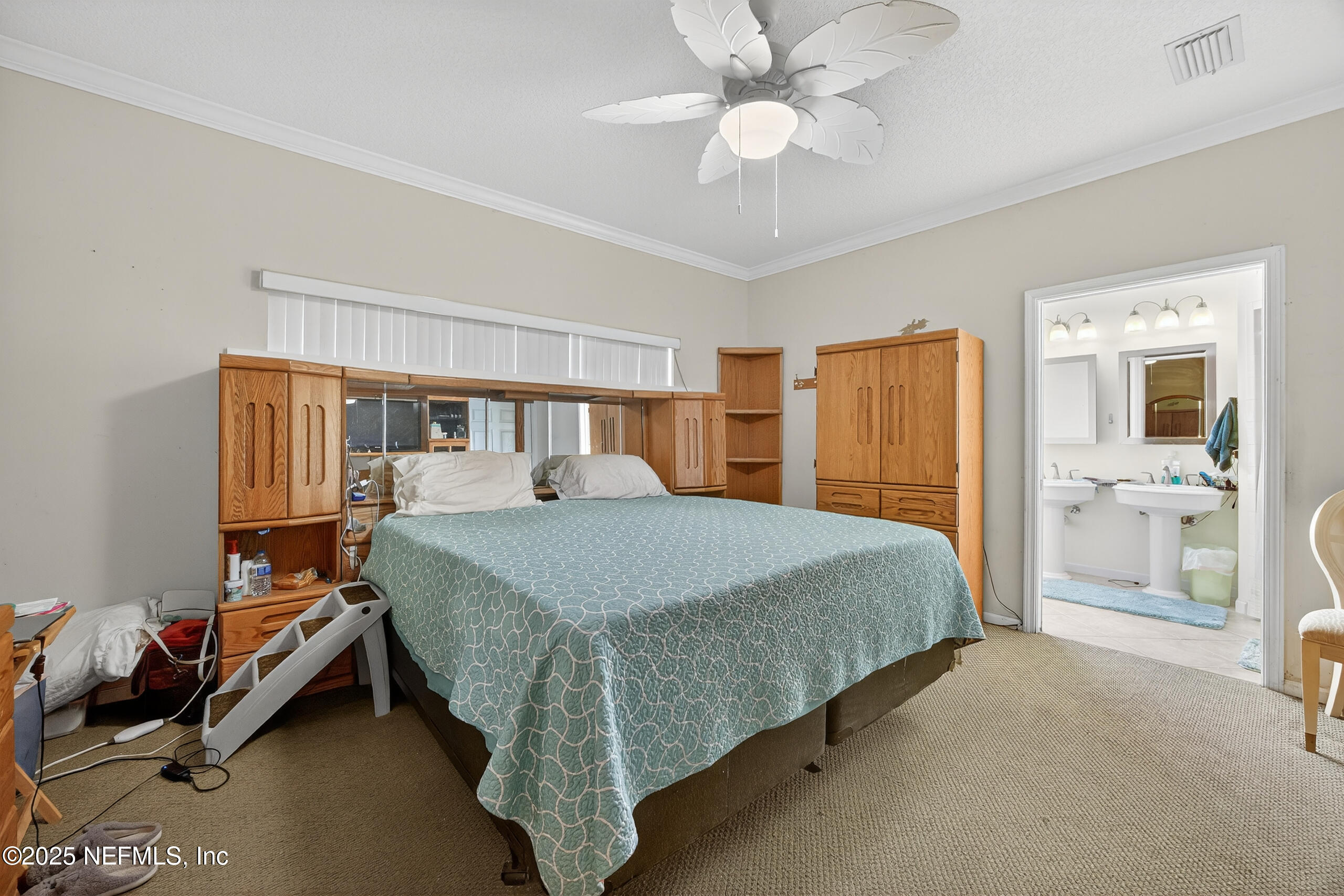 11319 Simmons Road Jacksonville, FL 32218 - Photo 16 of 32 a bed room with a bed and a chandelier