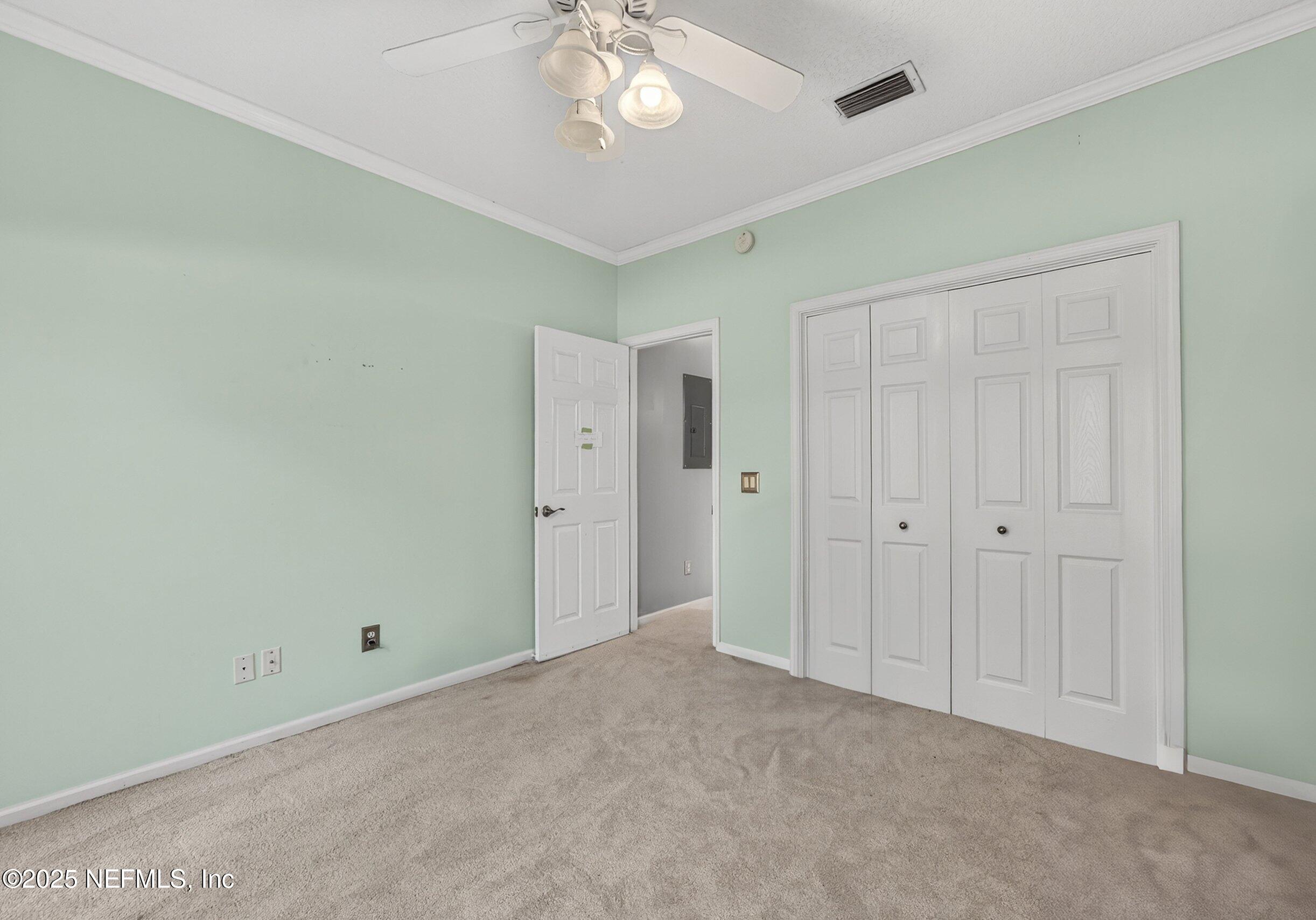 11319 Simmons Road Jacksonville, FL 32218 - Photo 20 of 32 a view of an empty room and a chandelier fan