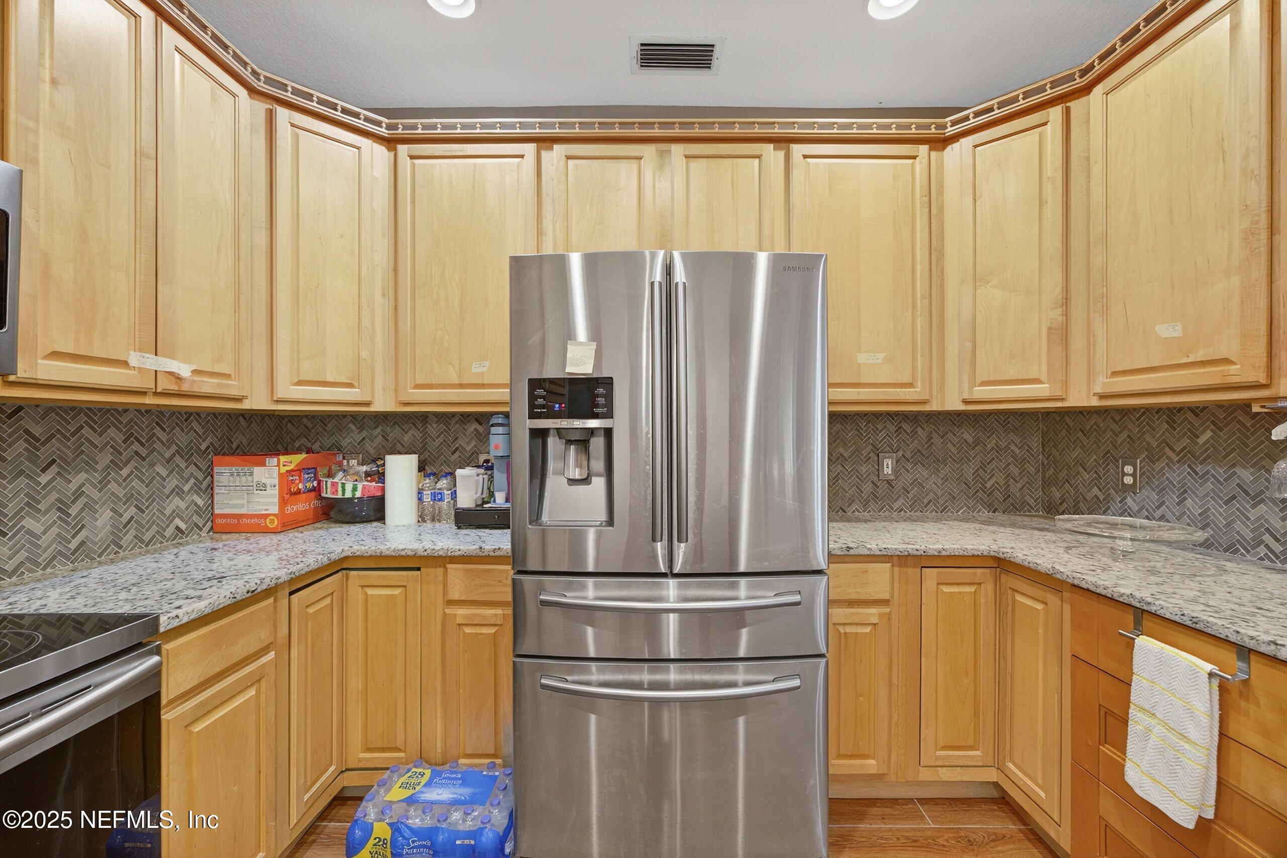 11319 Simmons Road Jacksonville, FL 32218 - Photo 2 of 32 a kitchen with stainless steel appliances granite countertop a refrigerator and a sink