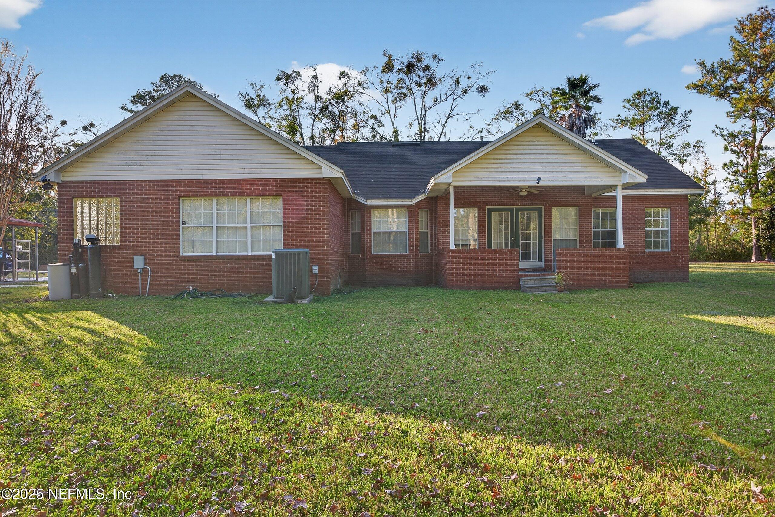 11319 Simmons Road Jacksonville, FL 32218 - Photo 26 of 32 a front view of a house with a garden and yard