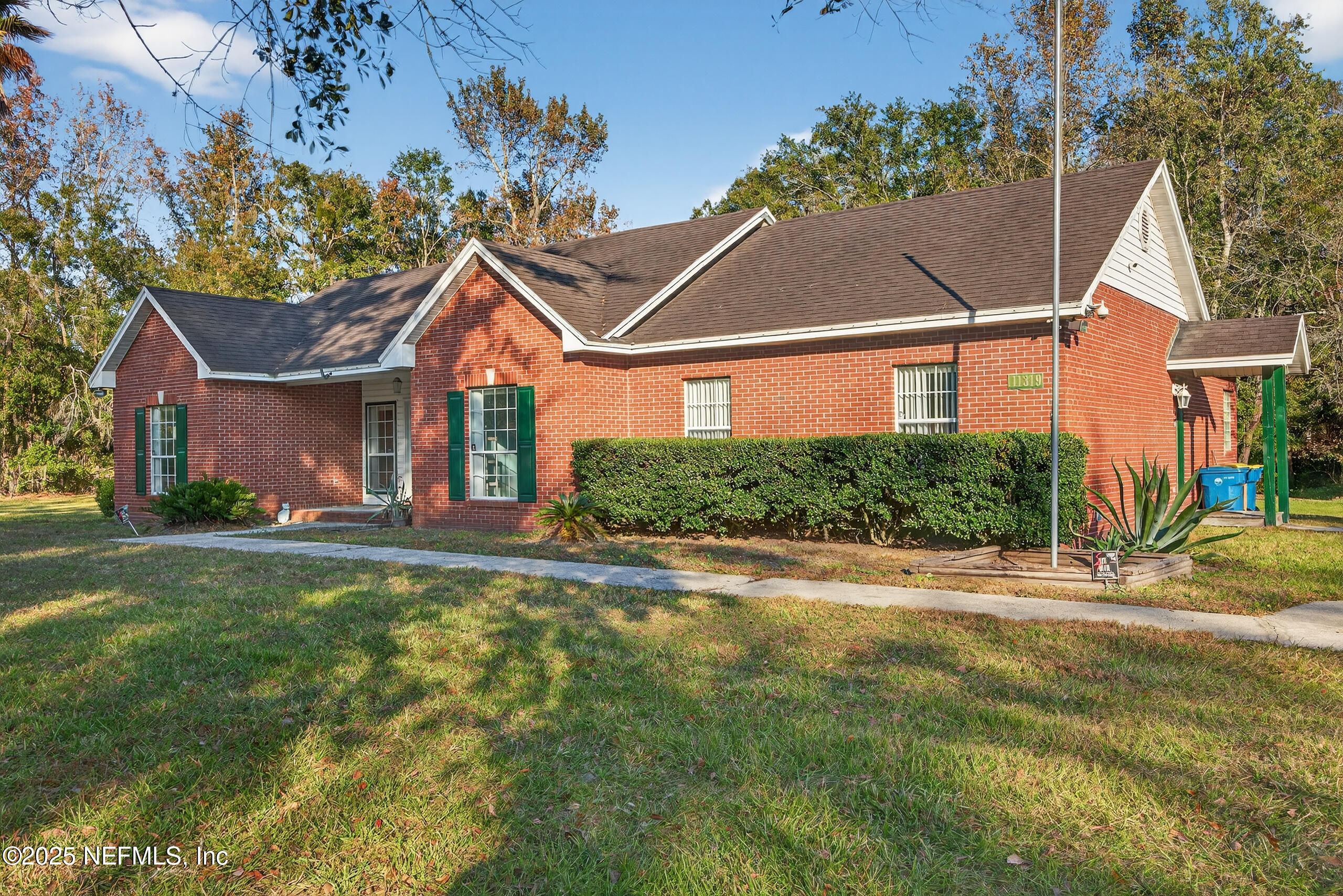 11319 Simmons Road Jacksonville, FL 32218 - Photo 6 of 32 front view of a house with a yard
