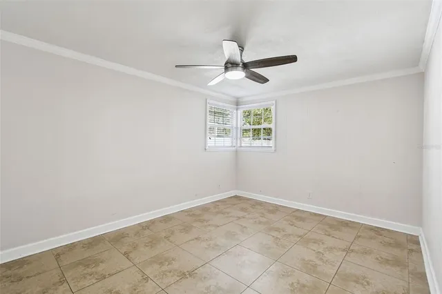 a view of an empty room with a ceiling fan