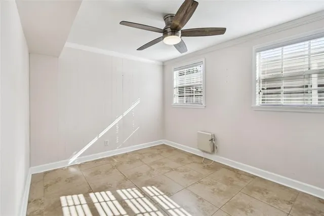 a view of empty room with ceiling fan