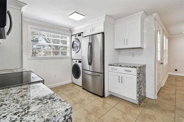 a kitchen with appliances cabinets and a window