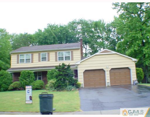 43 Pine Ridge Drive Edison, NJ 08820 - Photo 2 of 2 a front view of a house with a yard and garage