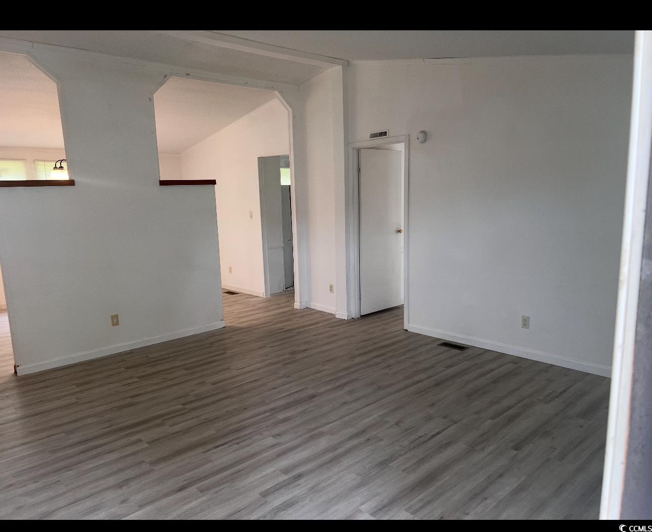 104 St Luke Church Road Winnsboro, SC 29180 - Photo 4 of 14 Empty room with wood finished floors, lofted ceili