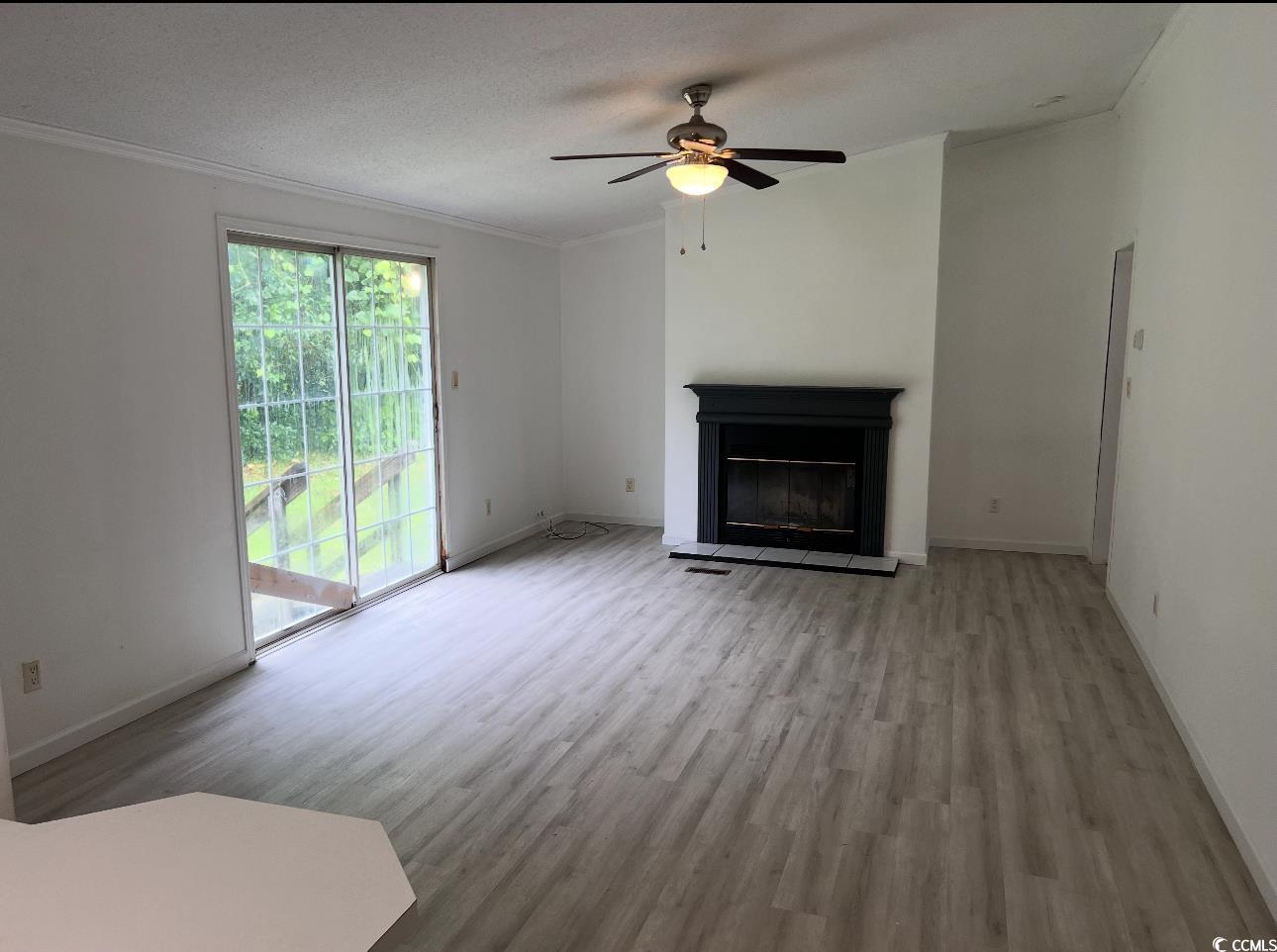 104 St Luke Church Road Winnsboro, SC 29180 - Photo 7 of 14 Unfurnished living room featuring wood finished fl