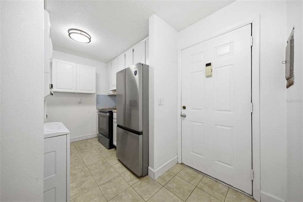 141 Fernery Road, Unit A3 Lakeland, FL 33809 - Photo 4 of 40 a view of a kitchen with a refrigerator and a sink