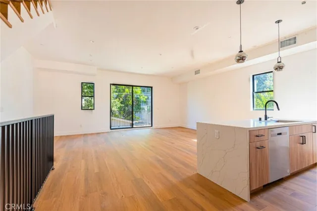 a view of a room with wooden floor