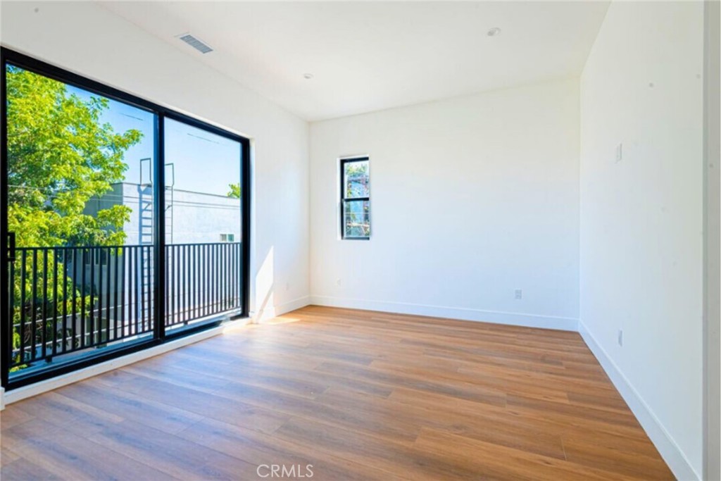 10847 Morrison Street North Hollywood, CA 91601 - Photo 5 of 13 an empty room with wooden floor and windows