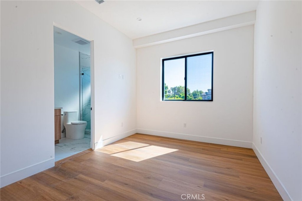 10847 Morrison Street North Hollywood, CA 91601 - Photo 7 of 13 an empty room with wooden floor and a window