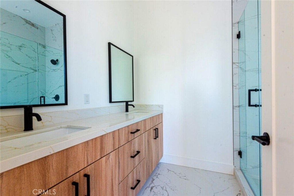 10847 Morrison Street North Hollywood, CA 91601 - Photo 10 of 13 a bathroom with a double vanity sink and mirror