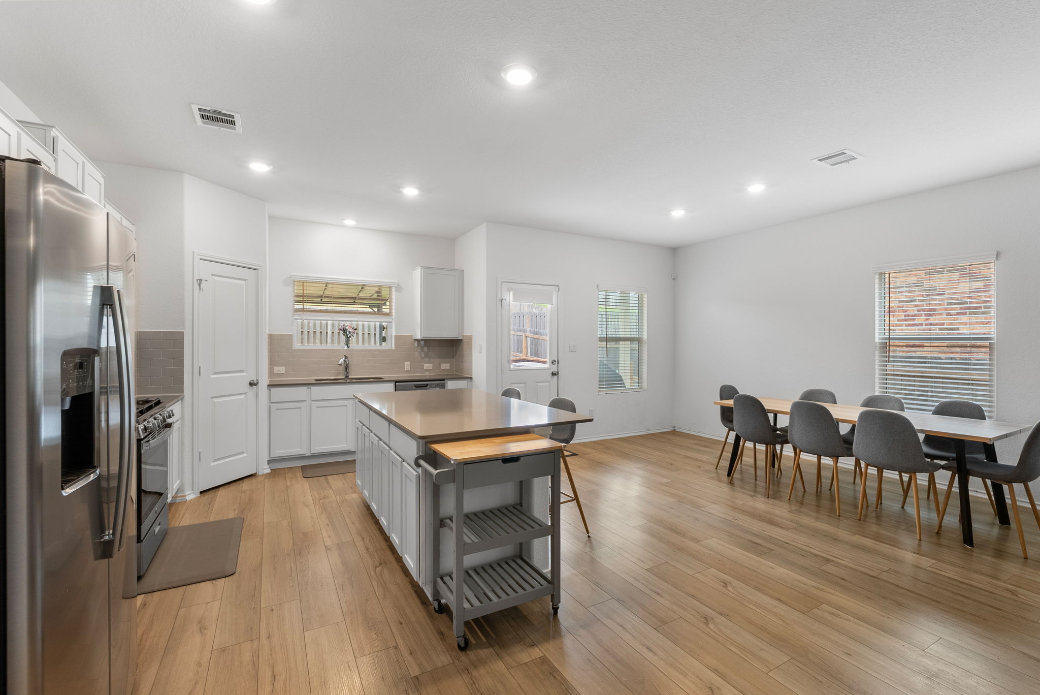 1240 Sweetspire Street Leander, TX 78641 - Photo 12 of 40 a large kitchen with a table and chairs