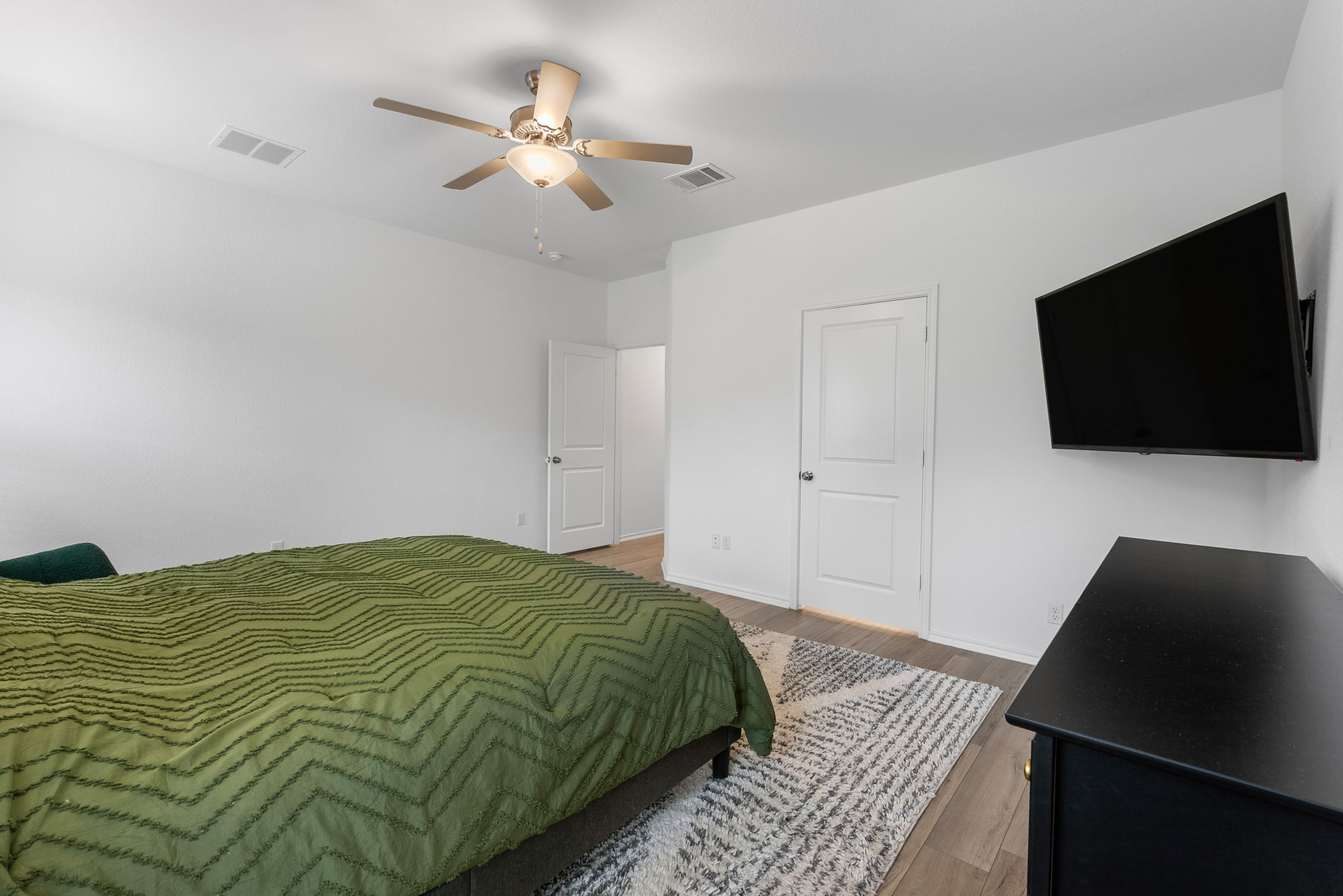 1240 Sweetspire Street Leander, TX 78641 - Photo 16 of 40 a bedroom with a bed and a flat screen tv