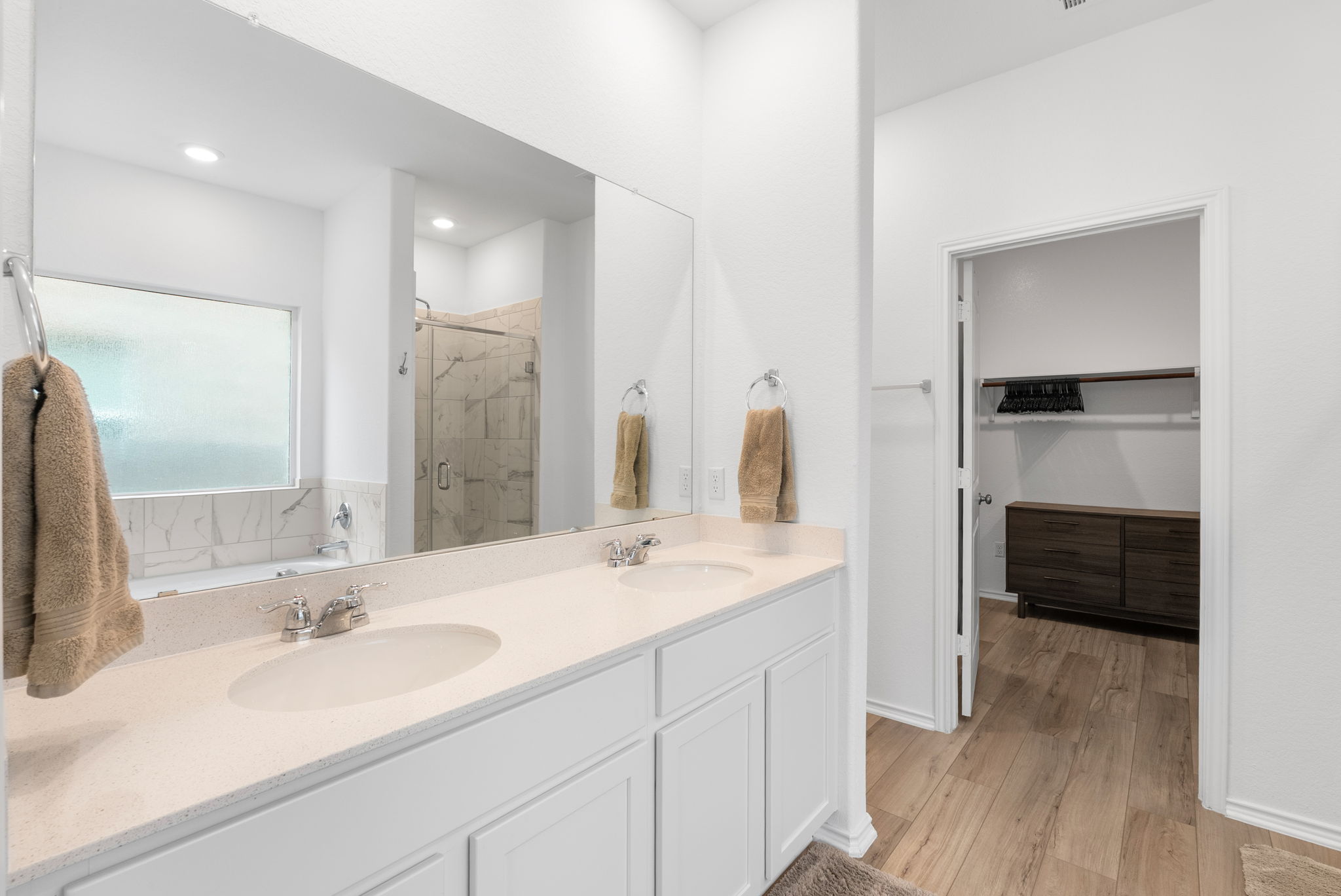 1240 Sweetspire Street Leander, TX 78641 - Photo 18 of 40 a bathroom with a double vanity sink a mirror and a shower