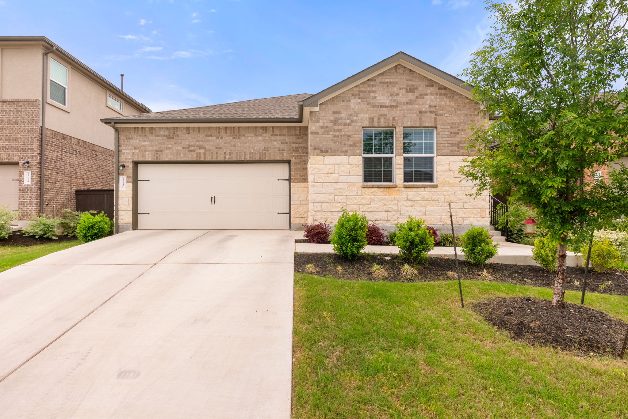 1240 Sweetspire Street Leander, TX 78641 - Photo 2 of 40 a front view of a house with garden