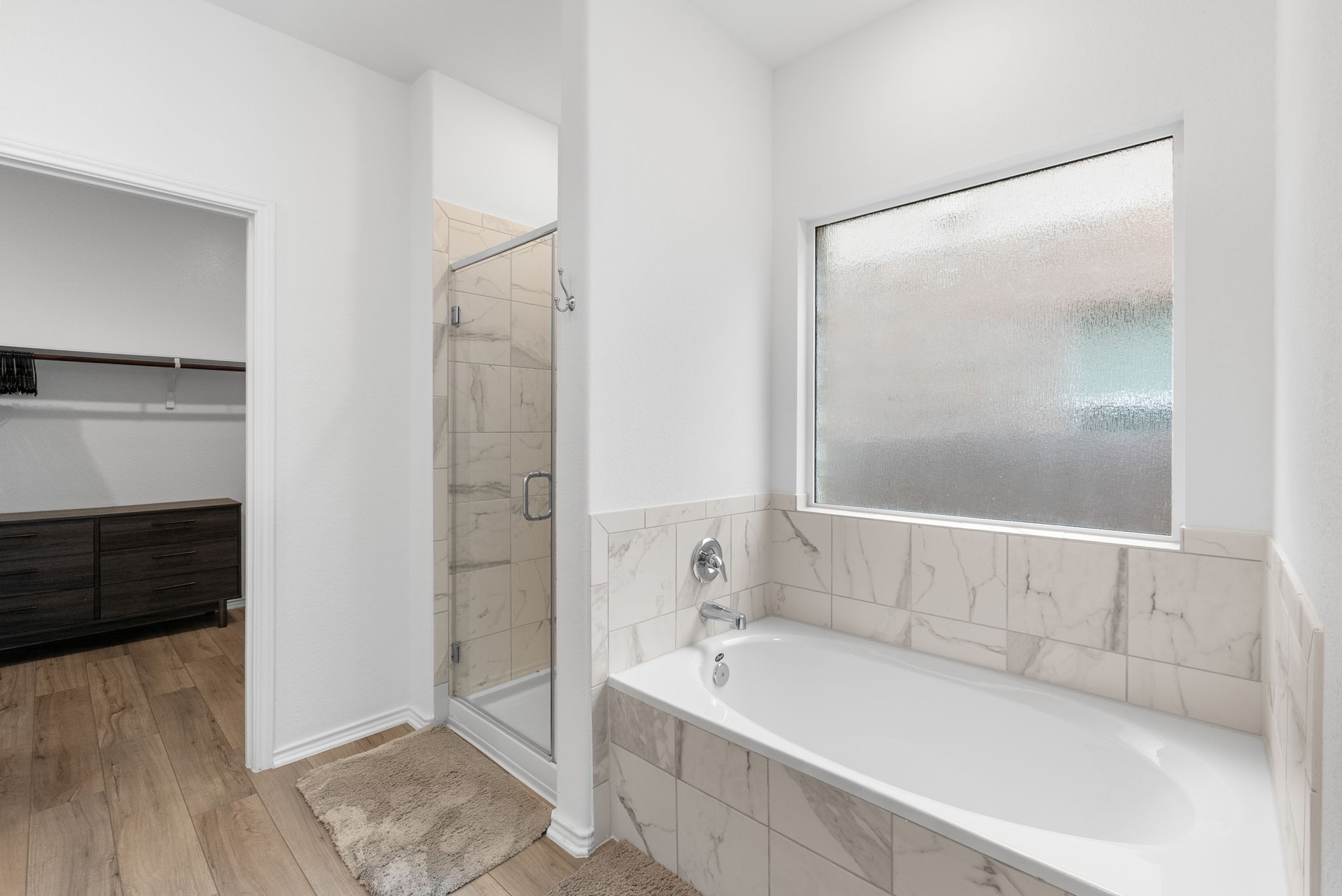 1240 Sweetspire Street Leander, TX 78641 - Photo 19 of 40 a bathroom with a bathtub and a shower