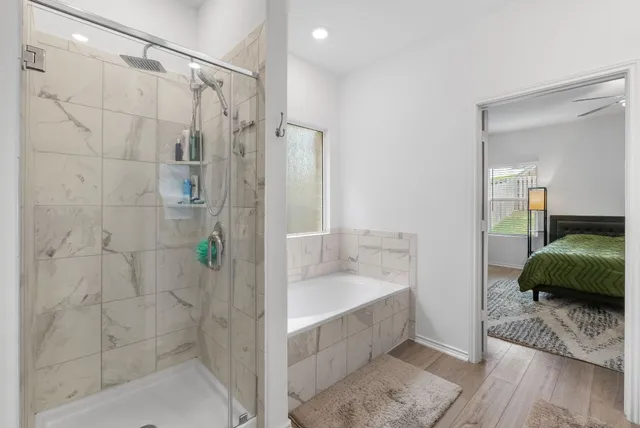 a bathroom with a double vanity sink a mirror and a shower