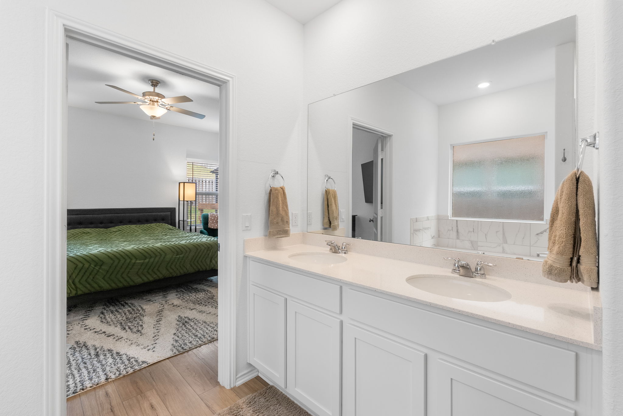 1240 Sweetspire Street Leander, TX 78641 - Photo 21 of 40 a en suite bathroom with a double vanity sink and a mirror