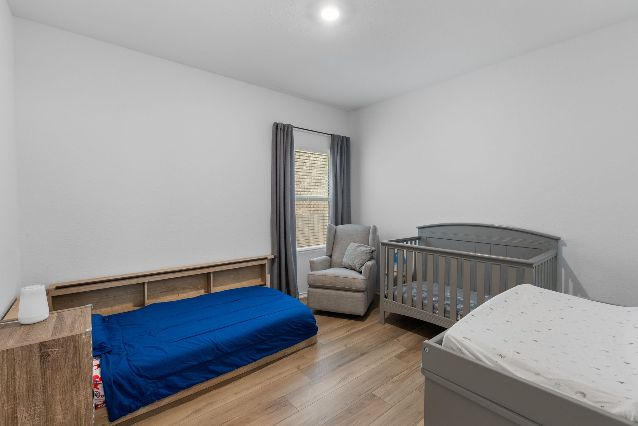 1240 Sweetspire Street Leander, TX 78641 - Photo 25 of 40 a bedroom with a bed and wooden floor