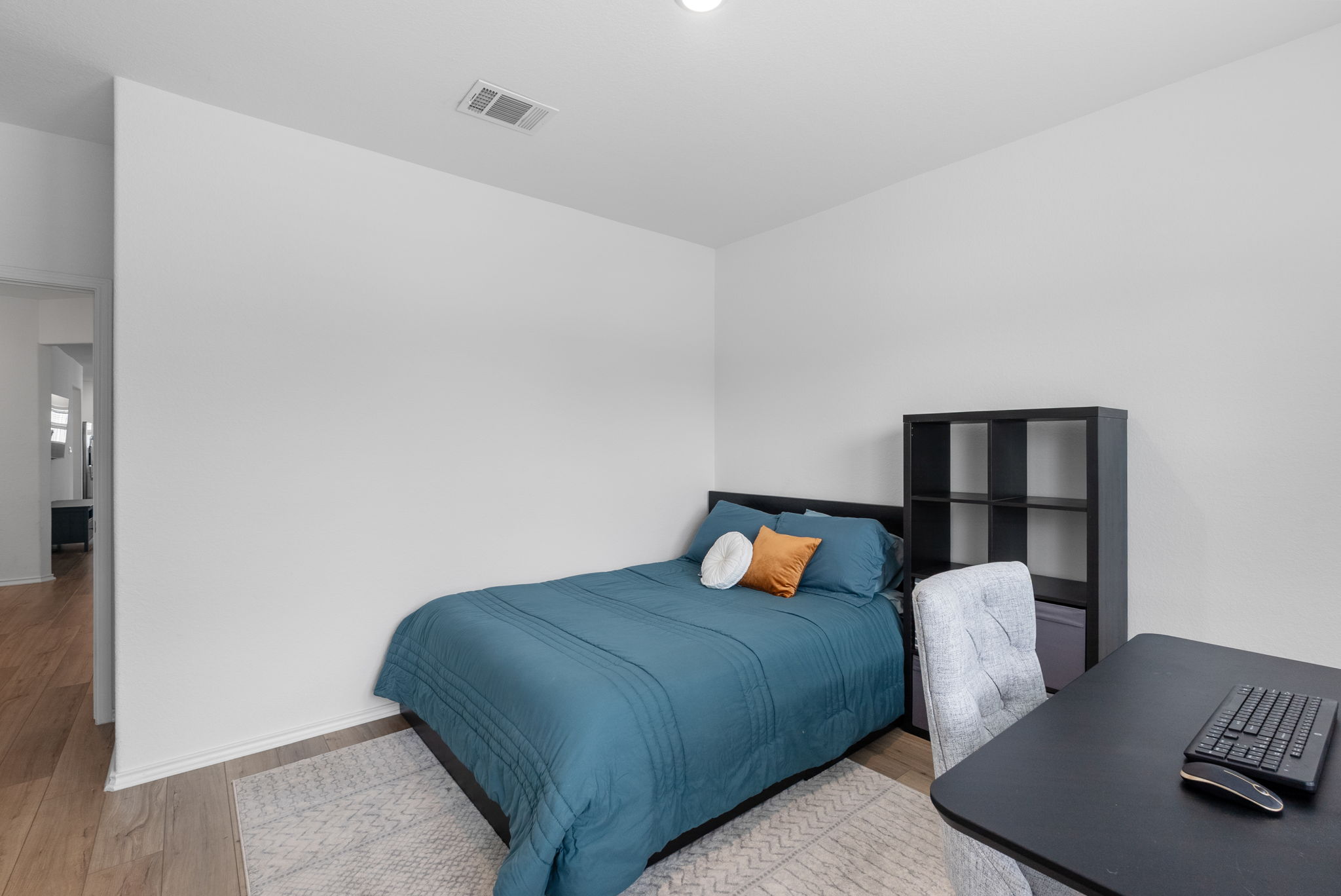 1240 Sweetspire Street Leander, TX 78641 - Photo 28 of 40 a bedroom with a bed and chair
