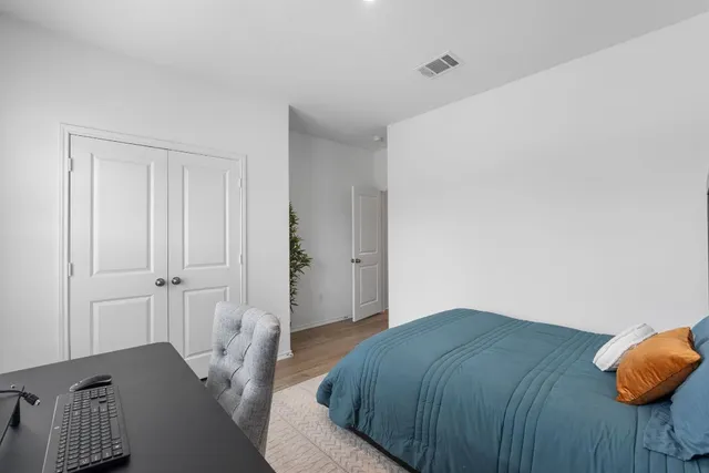 a bedroom with a bed and window