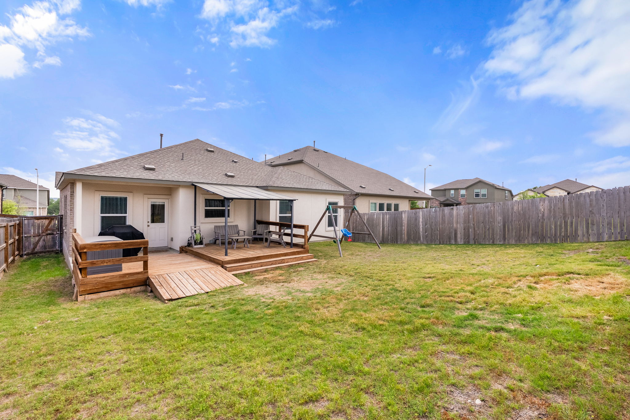 1240 Sweetspire Street Leander, TX 78641 - Photo 38 of 40 a white house with a big yard and wooden fence