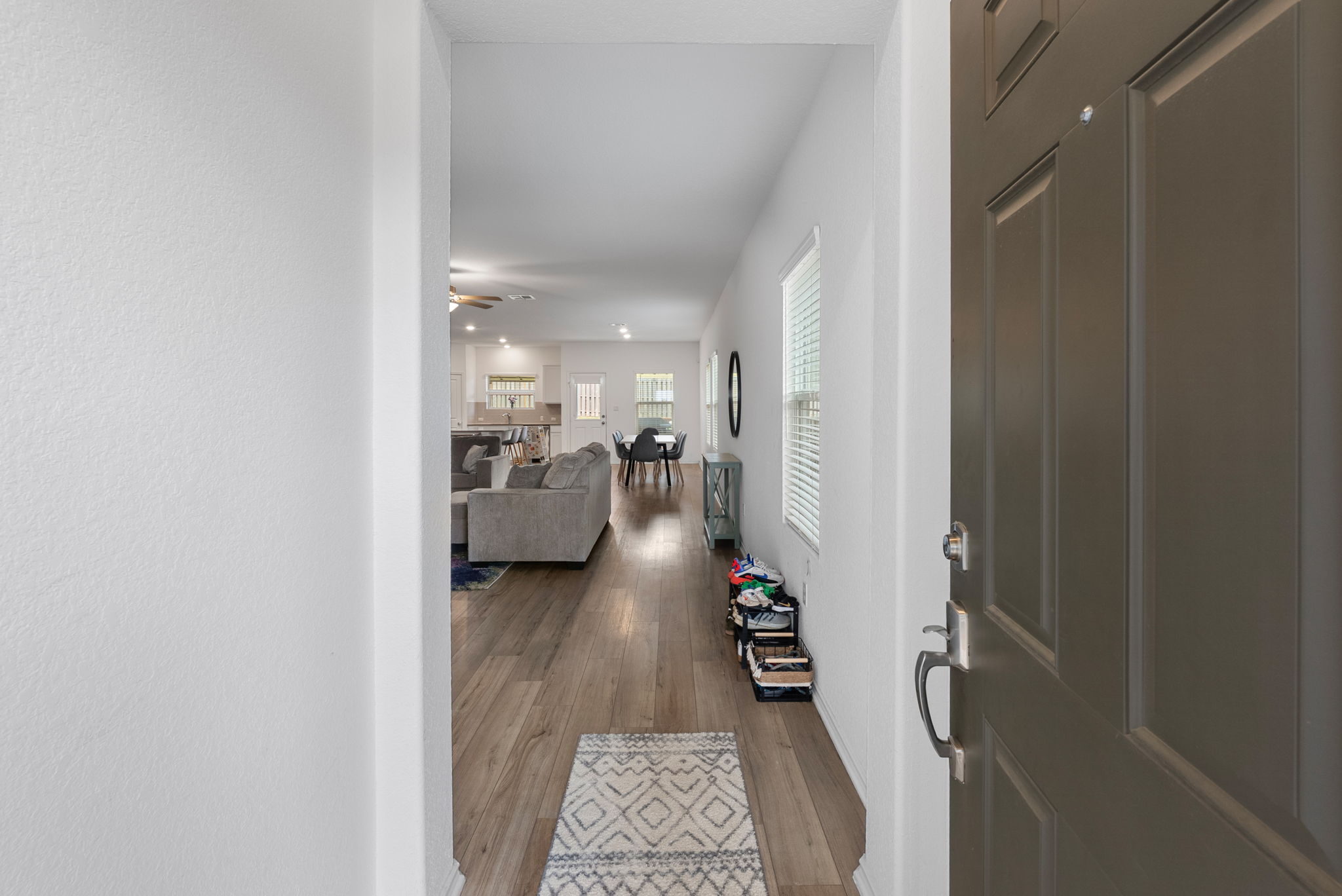 1240 Sweetspire Street Leander, TX 78641 - Photo 4 of 40 a hallway with a view of living room with a couch
