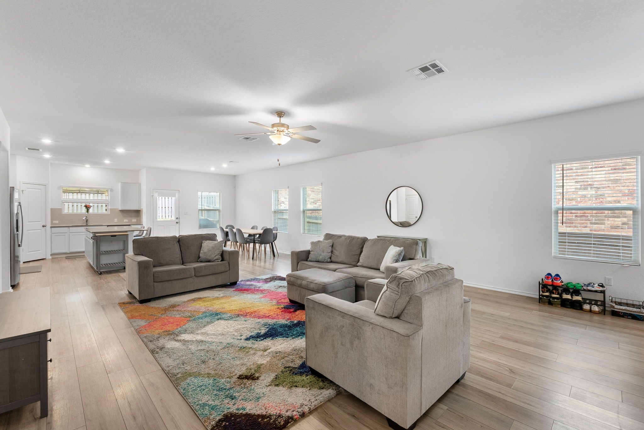 1240 Sweetspire Street Leander, TX 78641 - Photo 6 of 40 a living room with furniture and a chandelier