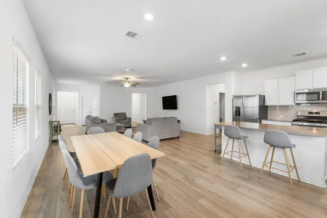 a view of a dining room with furniture and wooden floor