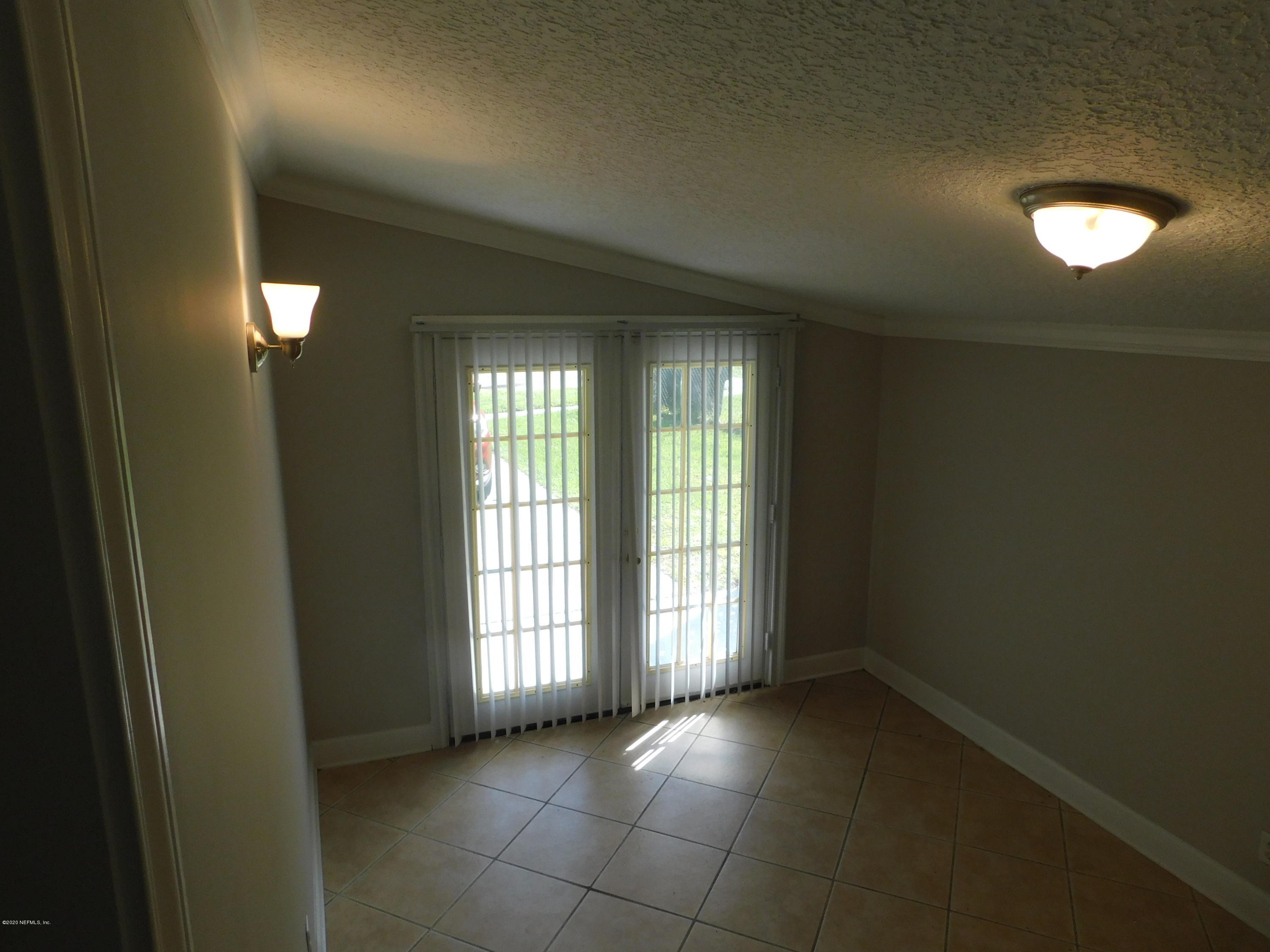 7413 Proxima Road Jacksonville, FL 32210 - Photo 11 of 24 a view of an empty room with a window