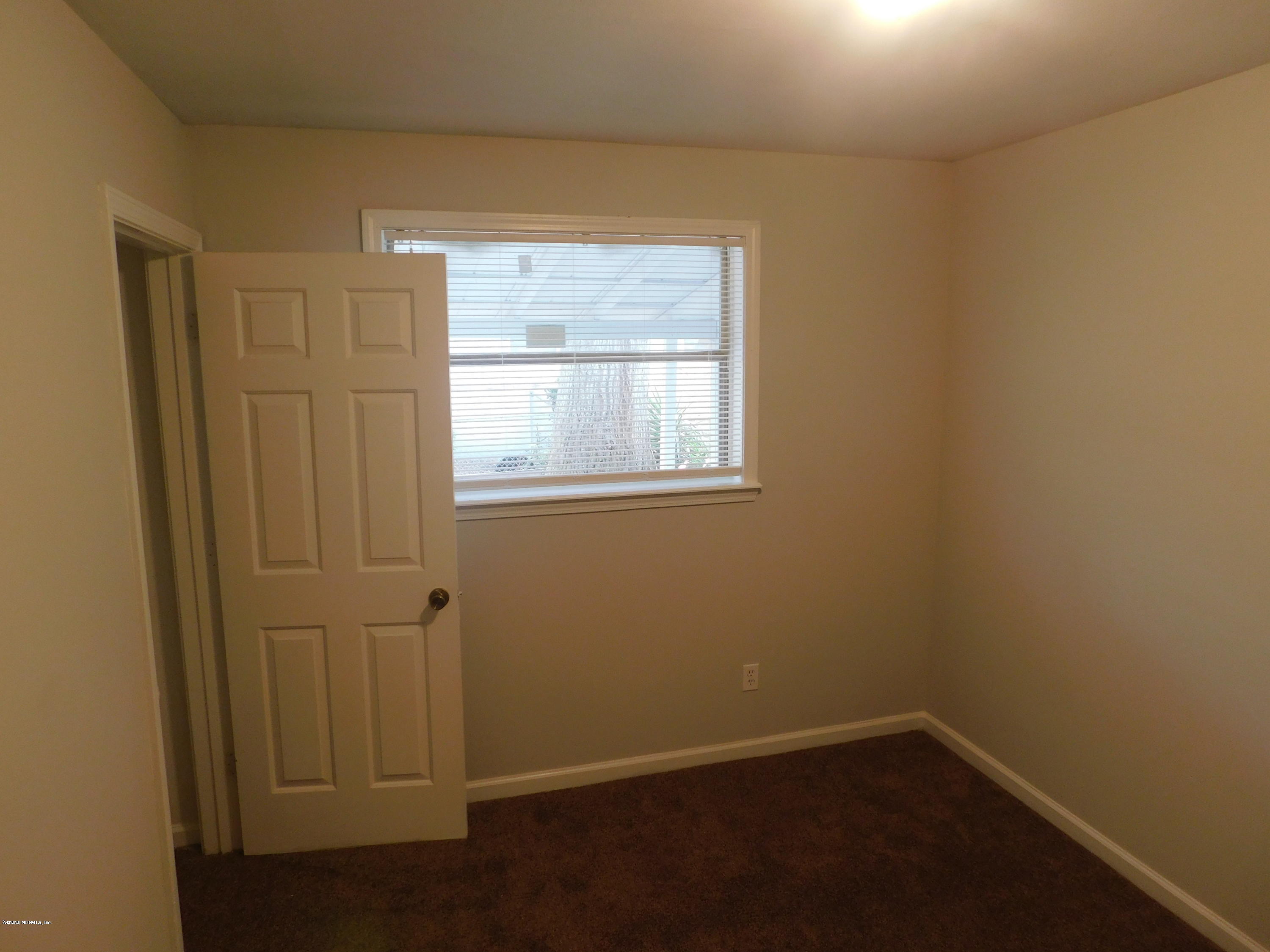 7413 Proxima Road Jacksonville, FL 32210 - Photo 12 of 24 an empty room with a window