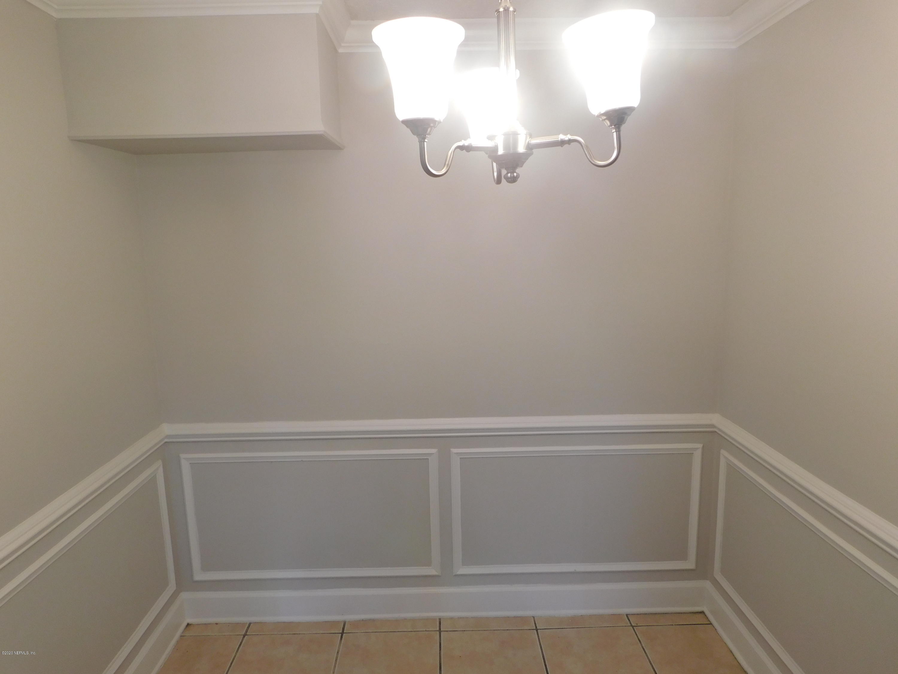 7413 Proxima Road Jacksonville, FL 32210 - Photo 7 of 24 a view of a small space with racks on the wall