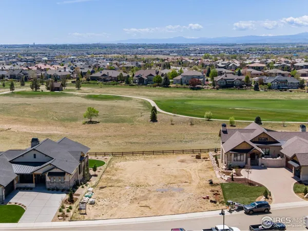 an aerial view of a house with a garden and lake view