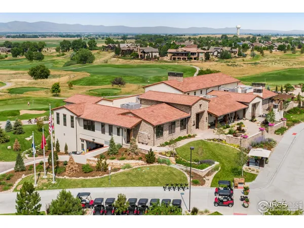 an aerial view of a house with a garden and lake view